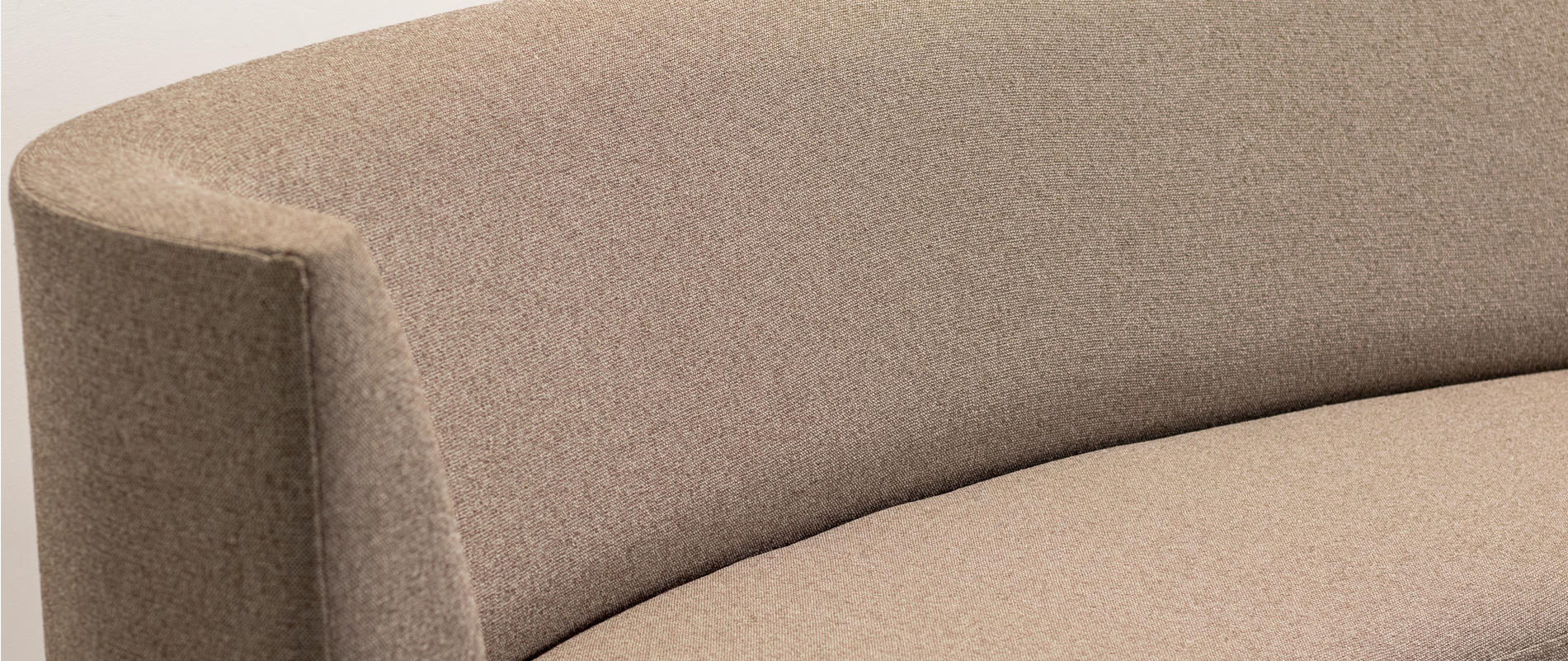 curved taupe sofa up close details